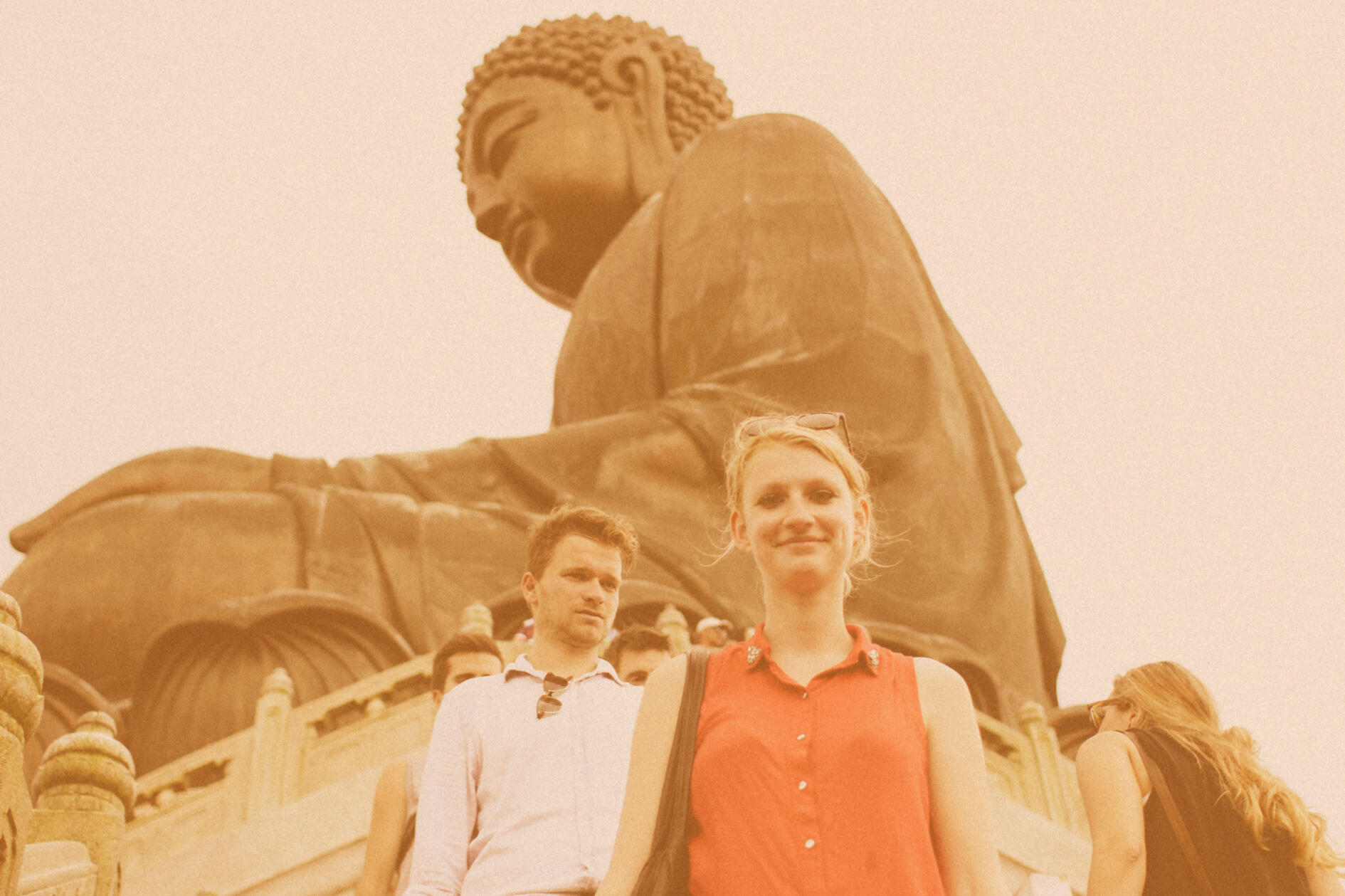 Two friends stand before the Tian Tan Buddha in Hong Kong, not yet knowing they would become a couple and have children.